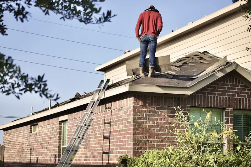 Professional roofer working on a residential roof in Braham